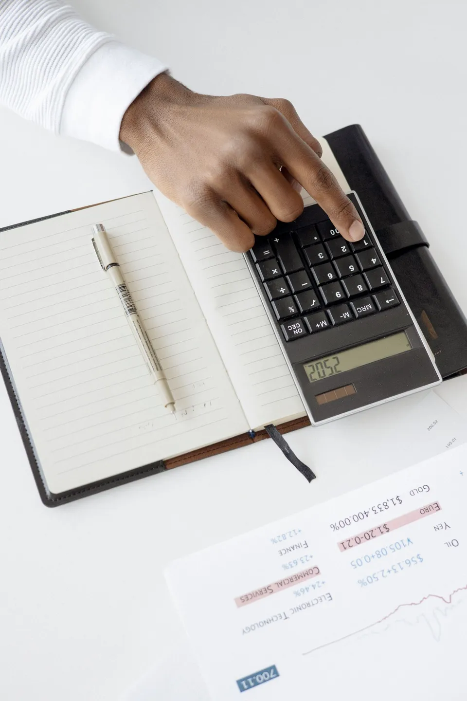 Calculatrice, carnet et documents financiers pour vérifier les comptes